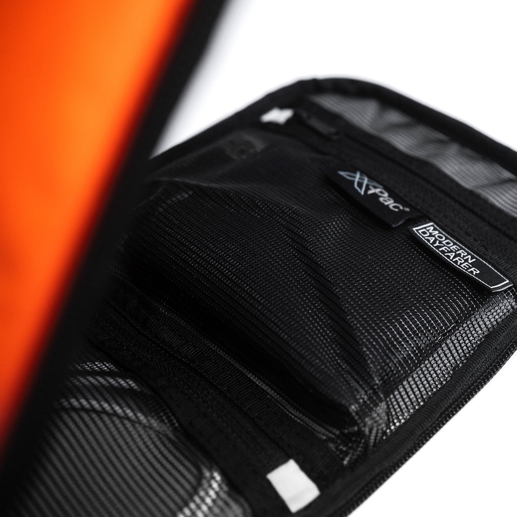 "MODERN DAYFARER Tech Pouch RVX25 - Keep your tech organized and protected in style with this sleek and durable pouch made of RVX25 X-Pac fabric by Dimension Polyant."